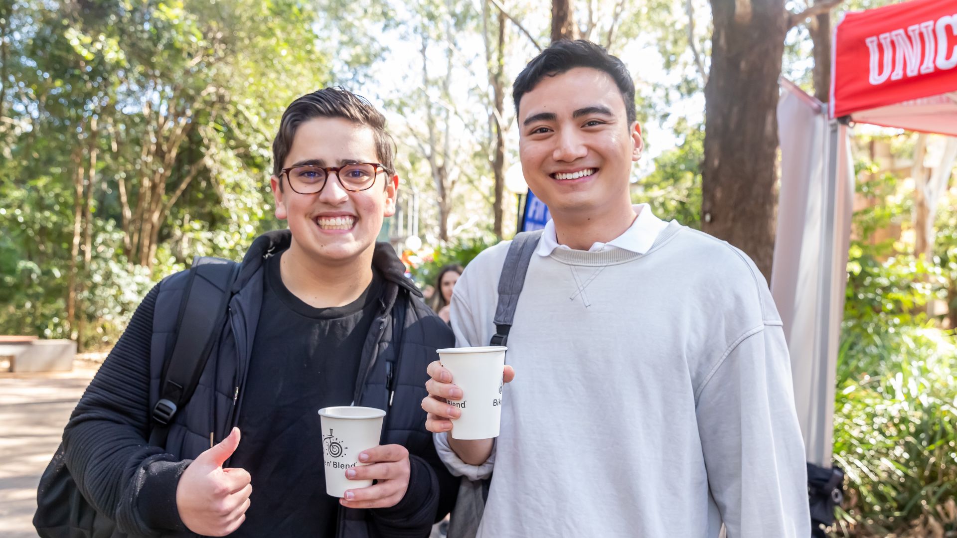 two people holding drinks